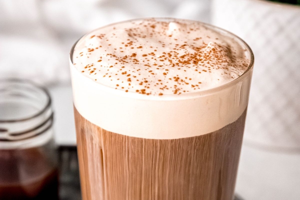 A Starbucks latte with whipped cream and cinnamon.