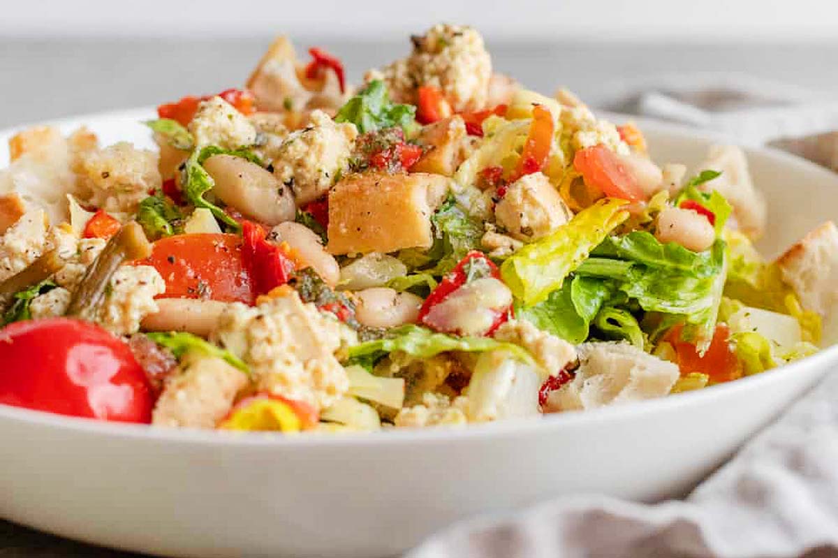 An Italian salad in a white bowl.