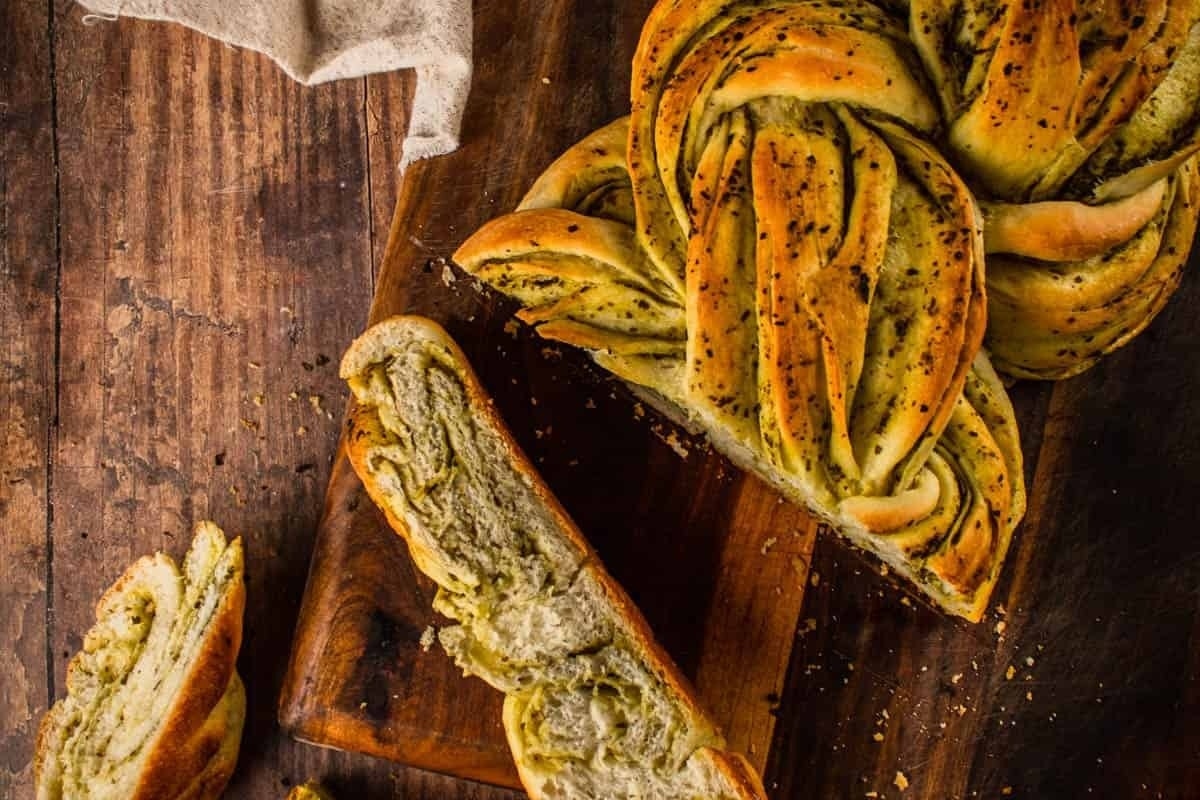 A rustic loaf of bread showcased on a wooden cutting board.