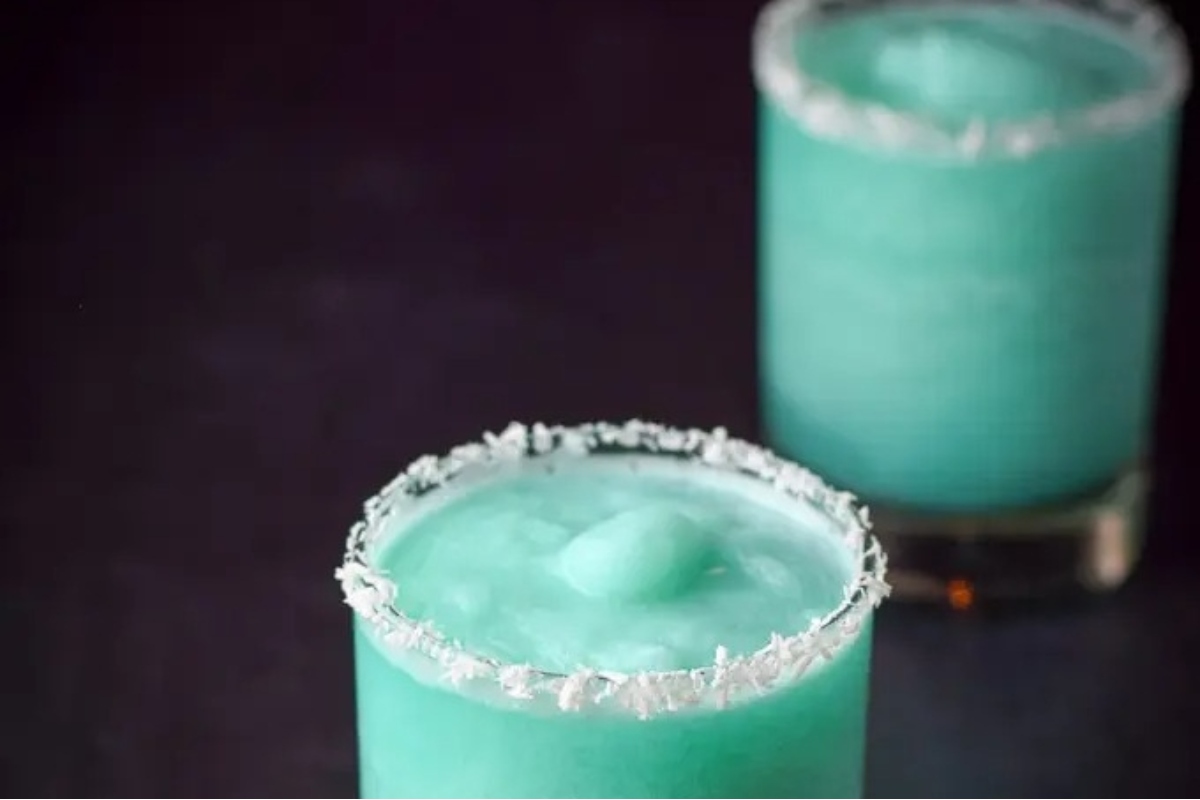 Two cocktails with a lime garnish.