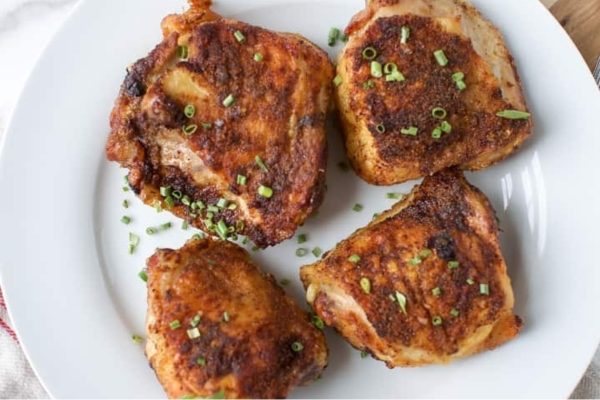 Grilled chicken breasts on a white plate.