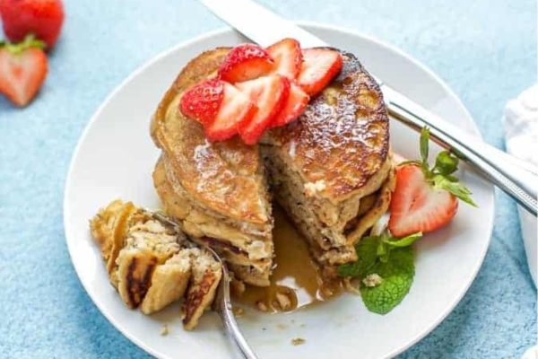 A plate of pancakes with strawberries on it.
