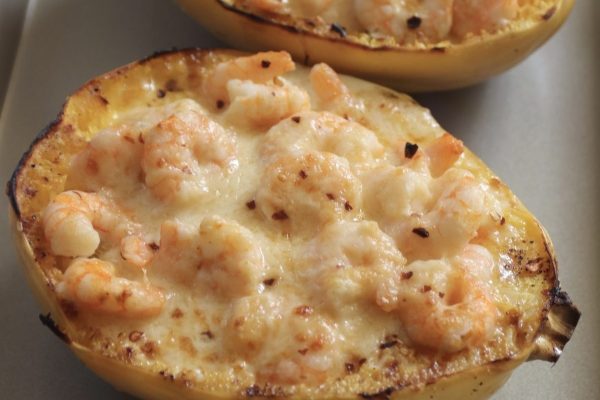 Two squash boats filled with shrimp and cheese.