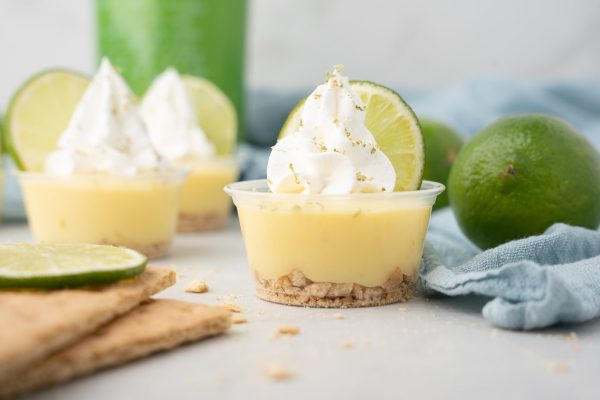 Mini lime pie cups with whipped cream and crackers made with Jello recipe.