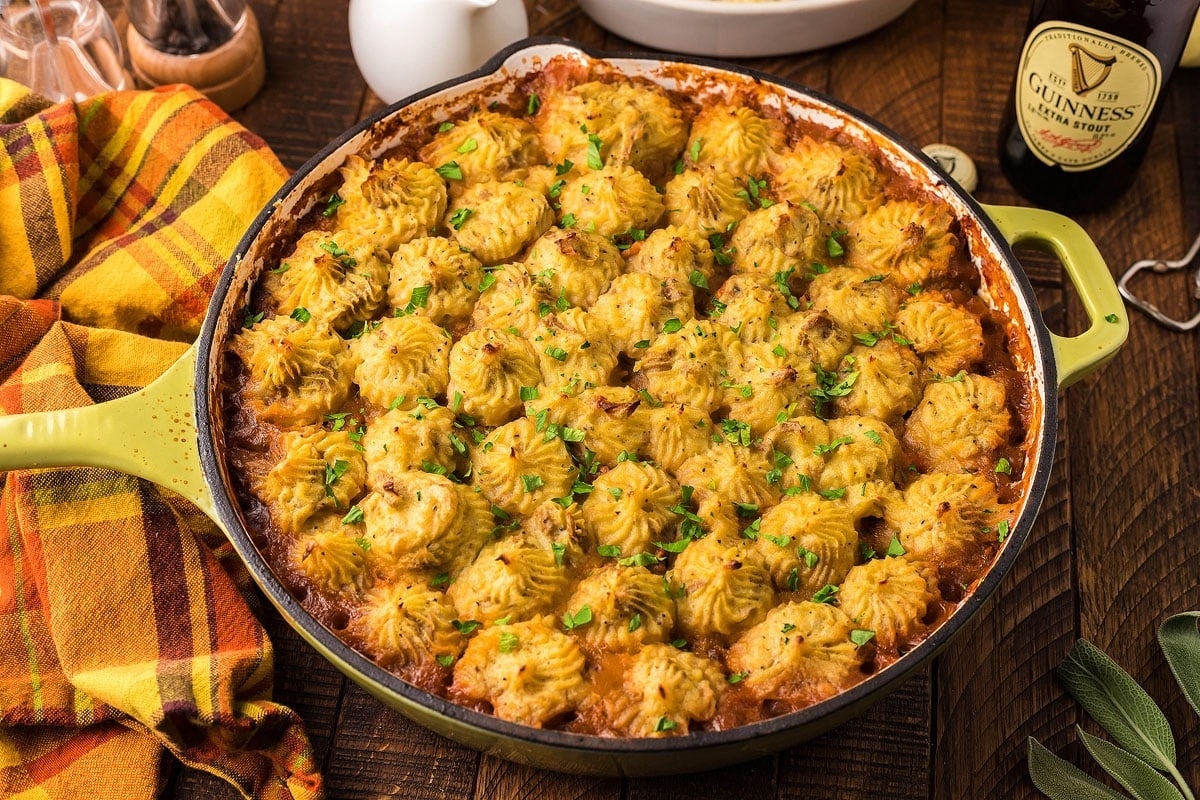 A pot of mashed potatoes and gravy on a table next to a bottle of beer. Perfect for using leftover turkey in delicious recipes.