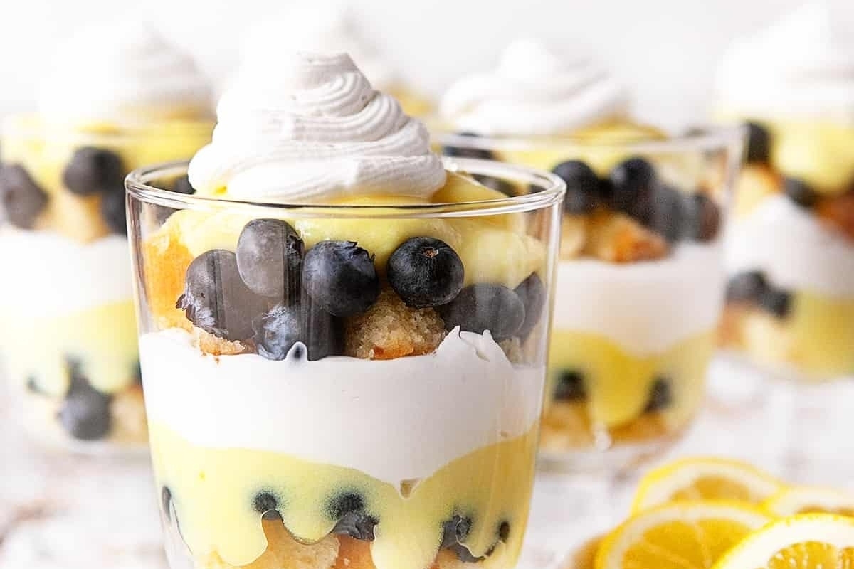 Trifles: Lemon blueberry trifles served in glasses with a dollop of whipped cream.