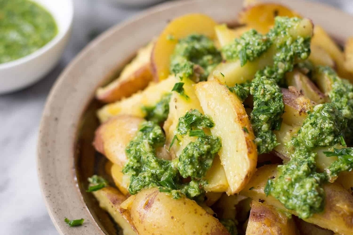 Thanksgiving potatoes with pesto sauce in a bowl.