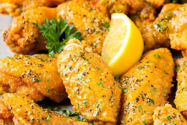 Game Day wings with lemon and parsley on a plate.