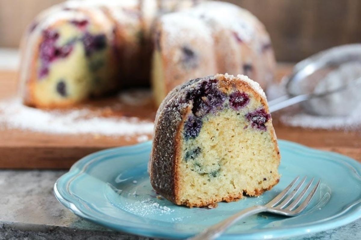 A bundt cake with powdered sugar on a plate.