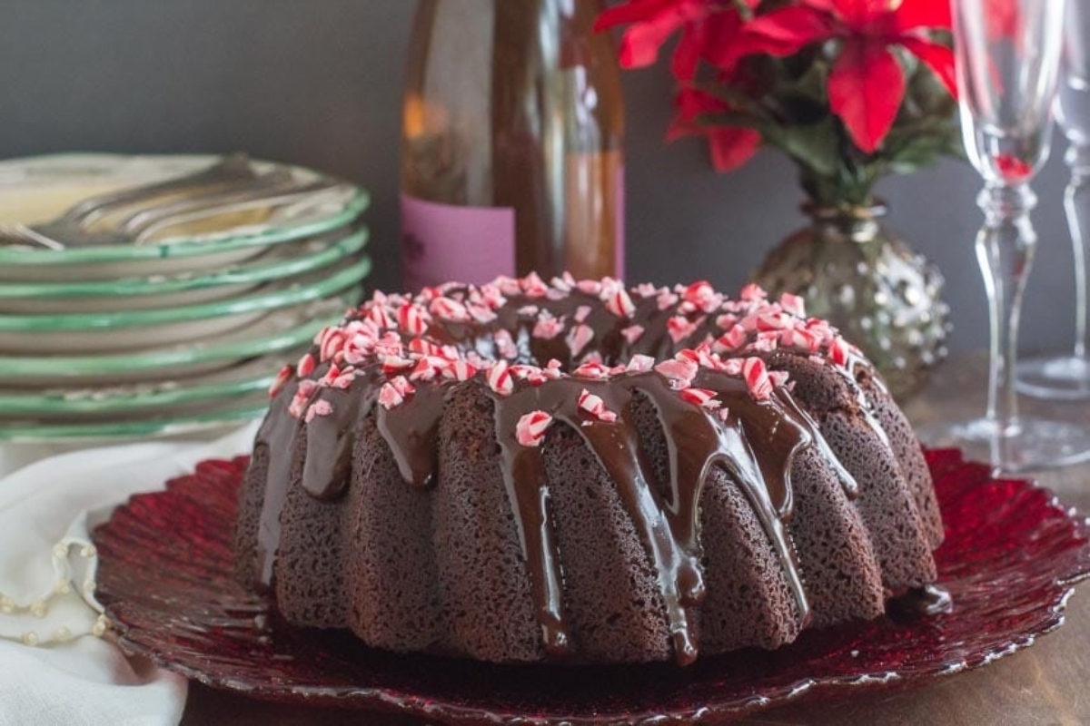 A Candy Cane Chocolate Bundt Cake with Peppermint Icing on a plate.
