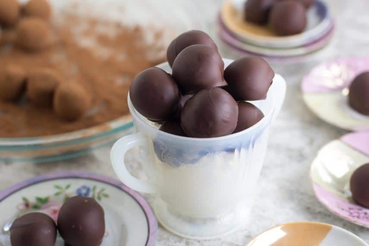 Edible chocolate balls in a cup on a plate.