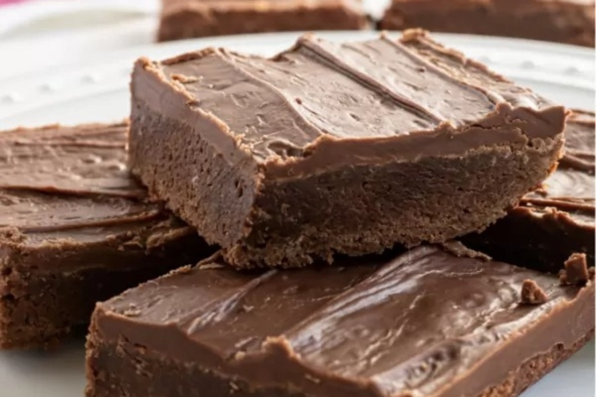 A plate filled with a stack of chocolate fudge brownies, deliciously prepared according to the best brownie recipes.