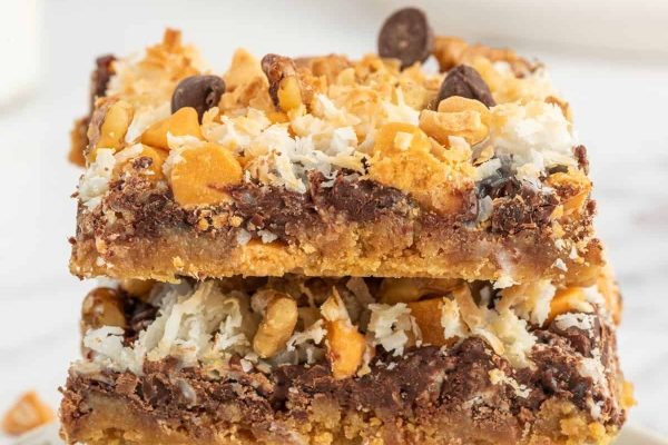 A stack of chocolate and graham cracker bars on a white plate.