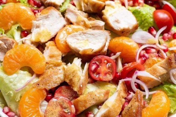 Chicken salad with pomegranate and oranges.
