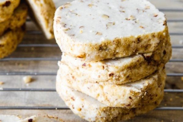 A stack of cookies on a cooling rack.