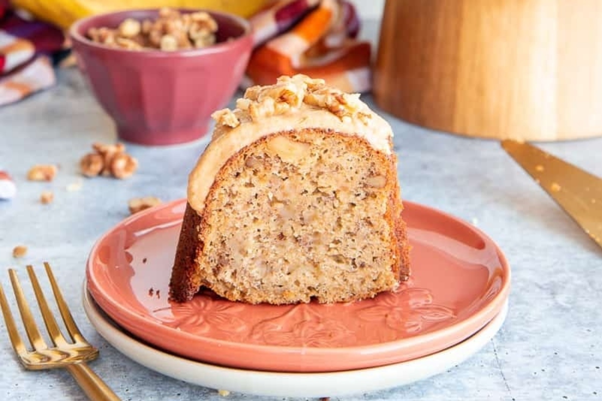 A slice of banana bundt cake on a plate with a fork.