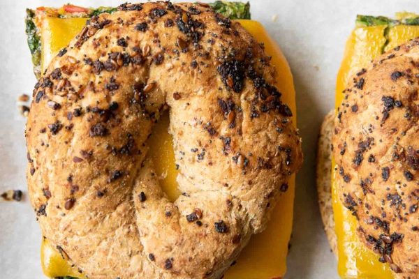 A satisfying breakfast meal prep option featuring two delicious bagels topped with spinach and peppers.