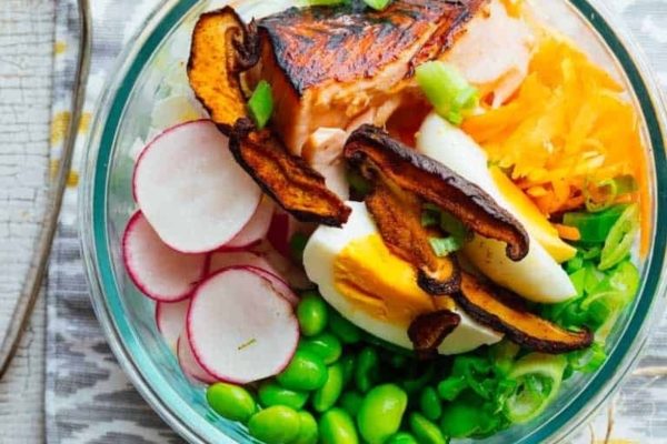 A bowl filled with salmon, radishes and eggs.