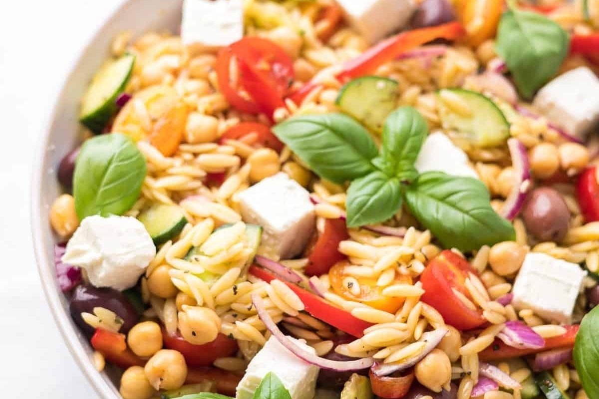 Italian orzo salad in a white bowl.