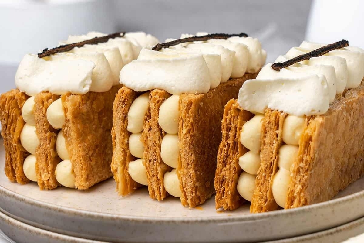 A plate with three puff pastries on it.