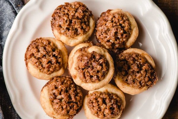 A white plate with a plate of pies on it.