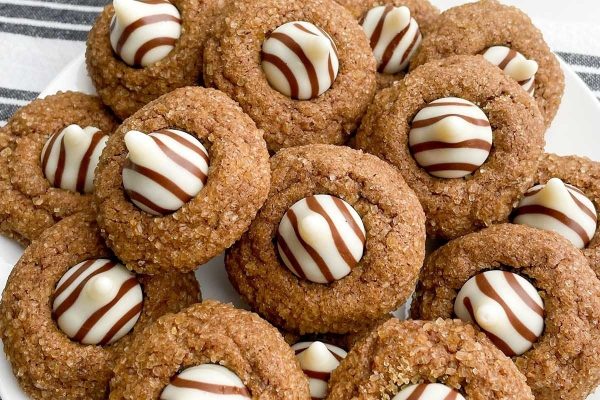 A plate of cookies with chocolate and white stripes.