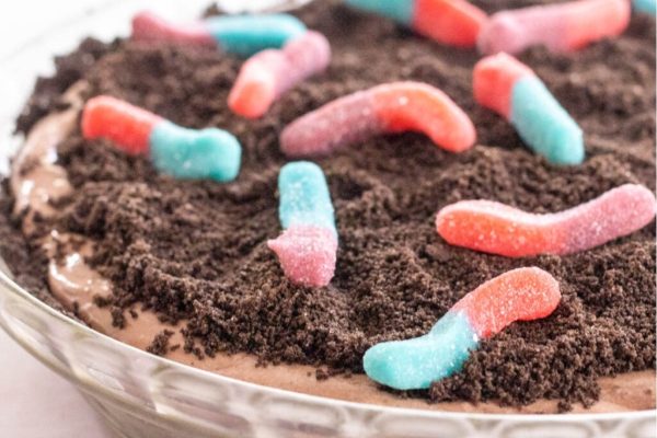 A pie with worms and candy in it.