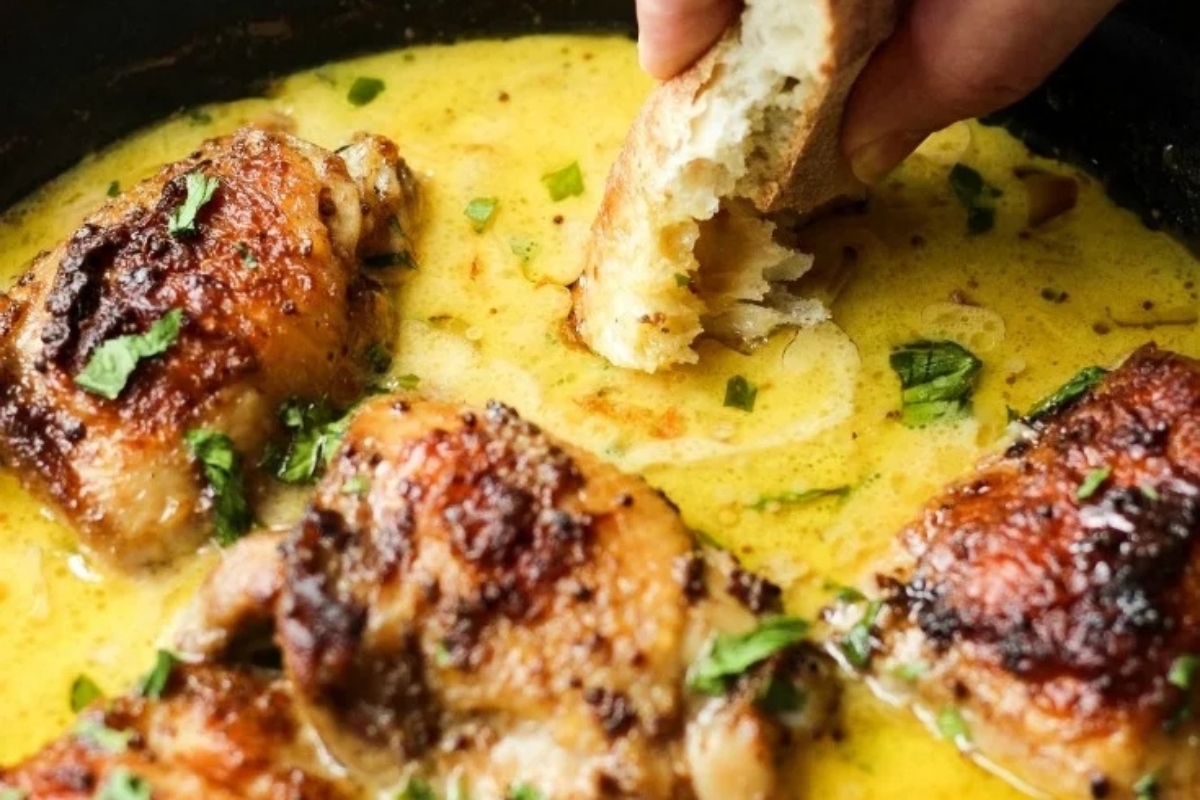 A Thanksgiving main dish featuring chicken cooked in a flavorful sauce with the addition of bread.