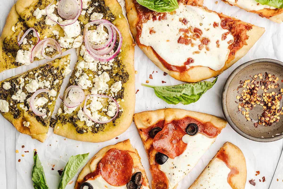Four slices of pizza on a white background.