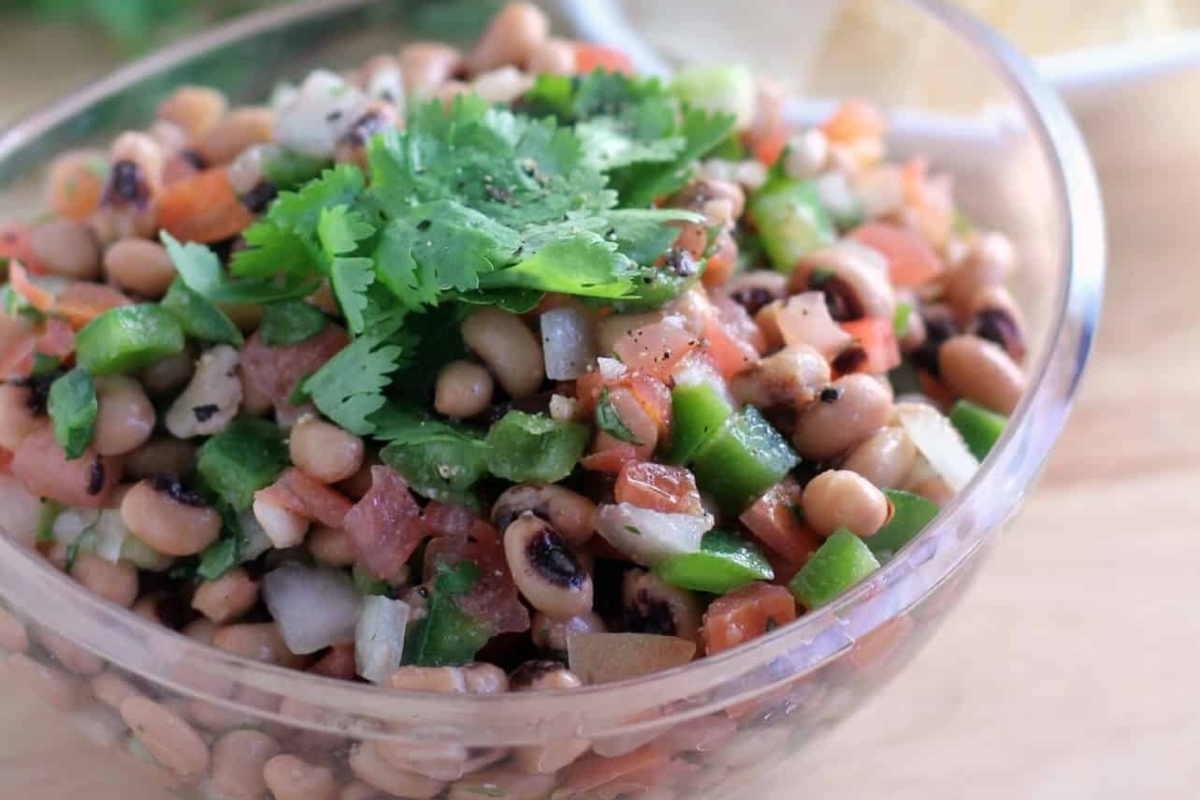 Delicious black eyed pea appetizer salad in a bowl perfect for New Year's Eve celebrations.
