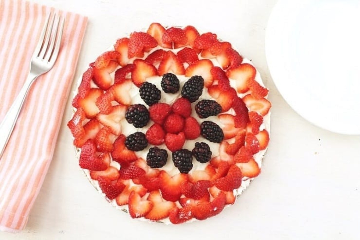 A plate with no bake desserts and a fork on it, topped with fresh berries.