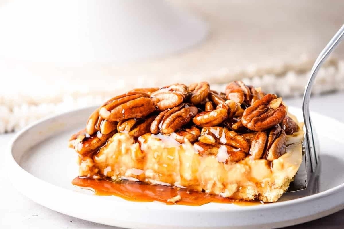 A scrumptious slice of pecan pie on a plate.