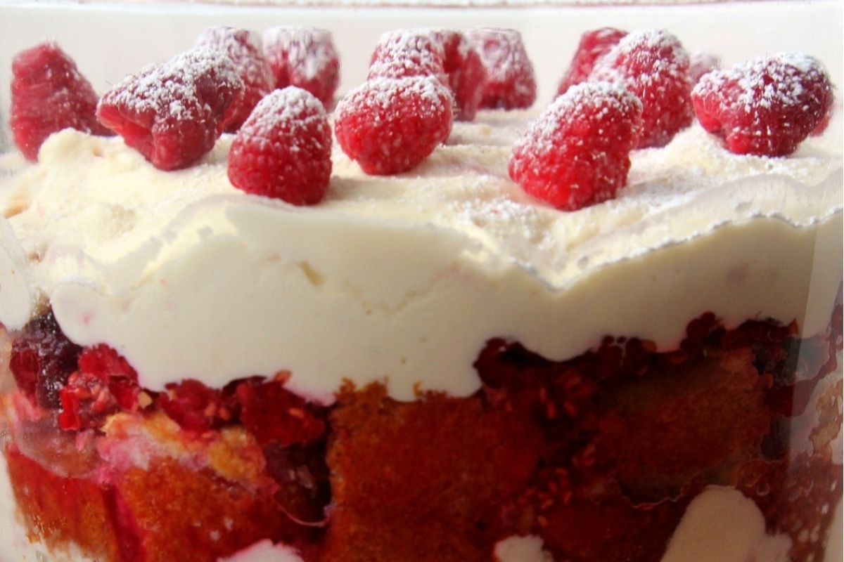 Trifles: Raspberry trifle elegantly presented in a clear glass dish.