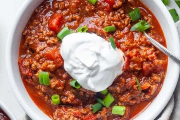 Chili in a bowl with sour cream.