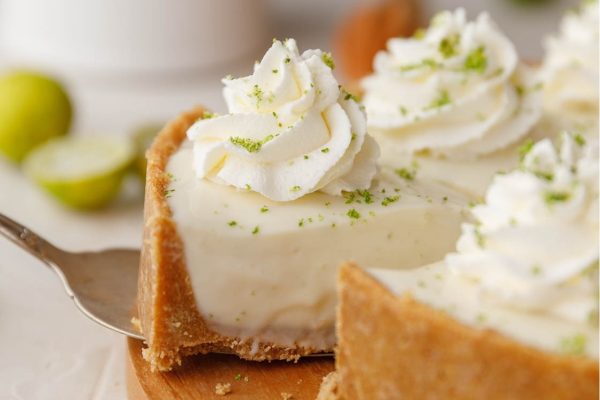 A slice of lime pie with whipped cream on top.