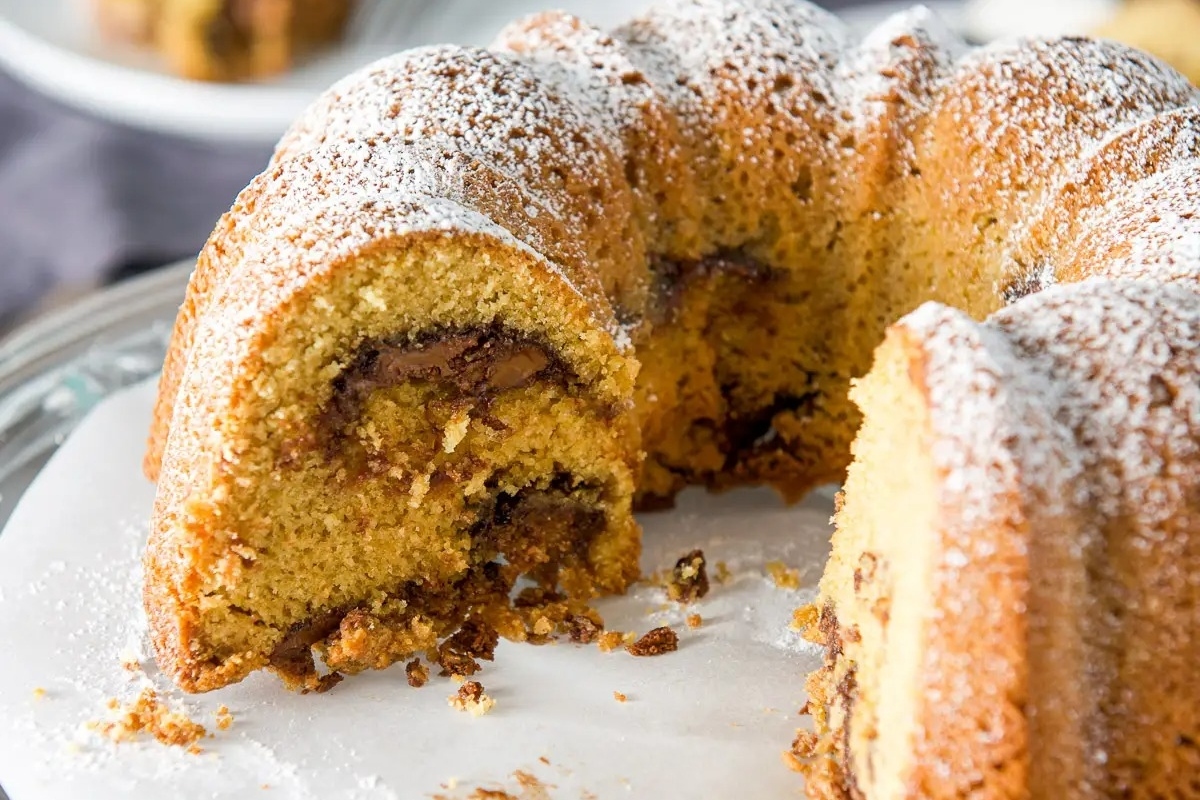 A delicious Nutella bundt cake with a slice taken out.