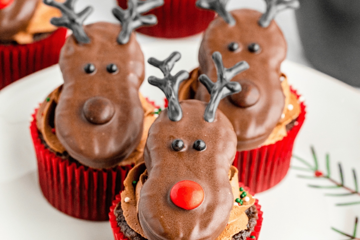 Cute Christmas cupcakes, shaped like reindeer, displayed on a plate.