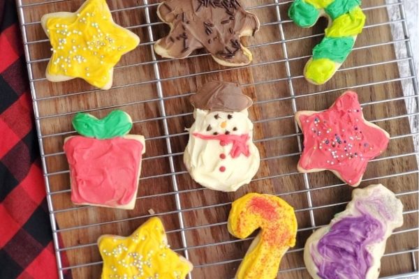 Christmas sugar cookies on a cooling rack.