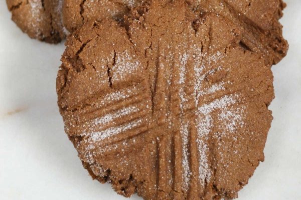 A group of cookies with powdered sugar on top.