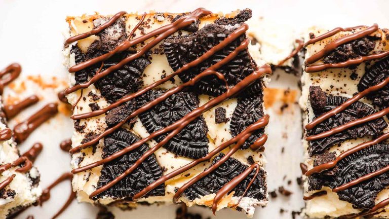 Delicious Oreo cheesecake bars on a white plate, perfect for indulging in your favorite Oreo recipes.