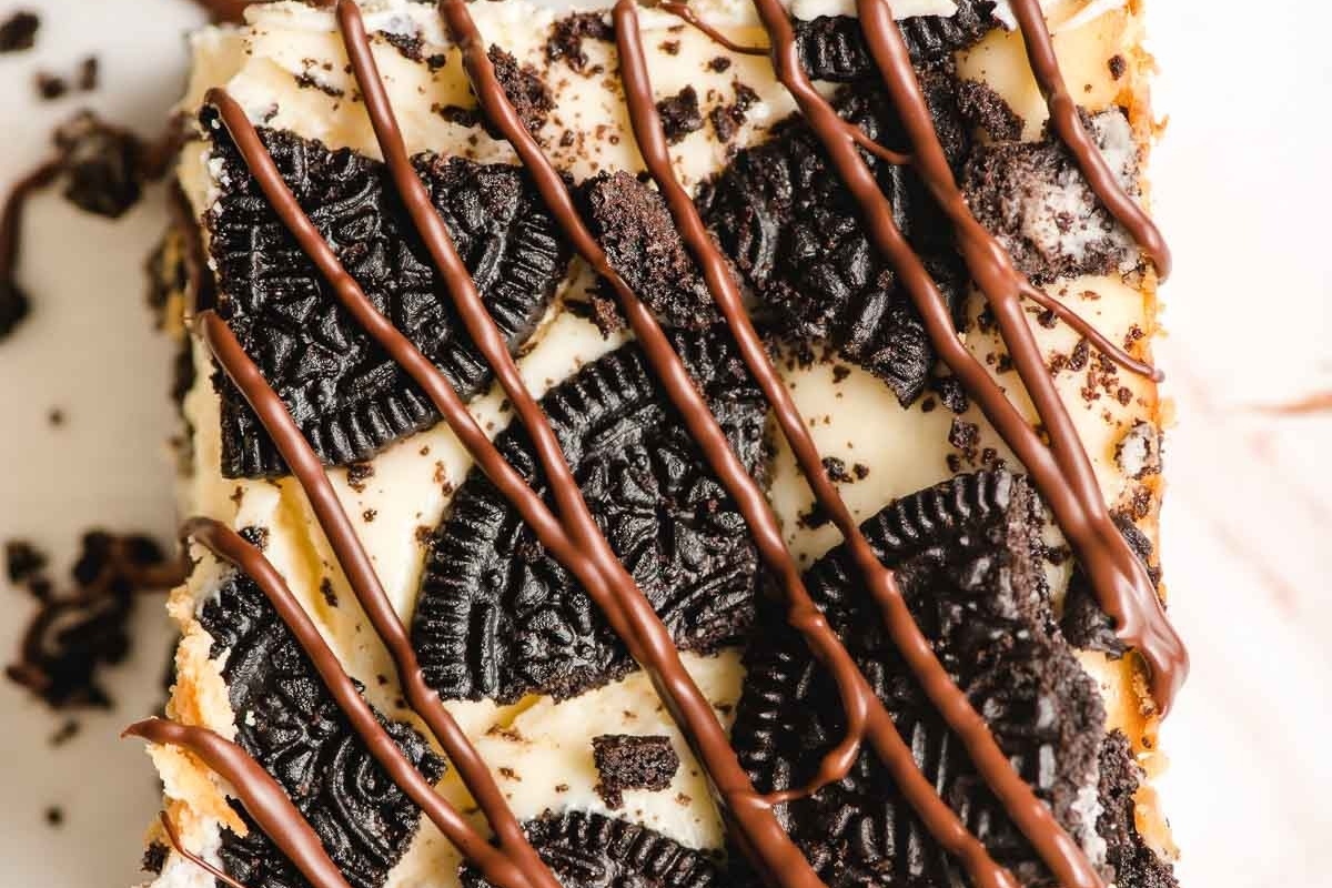 A delectable oreo ice cream cake perfectly topped with a rich chocolate drizzle.