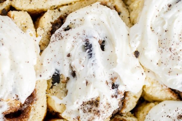 Cinnamon rolls topped with whipped cream and chocolate chips are the perfect indulgent treat.