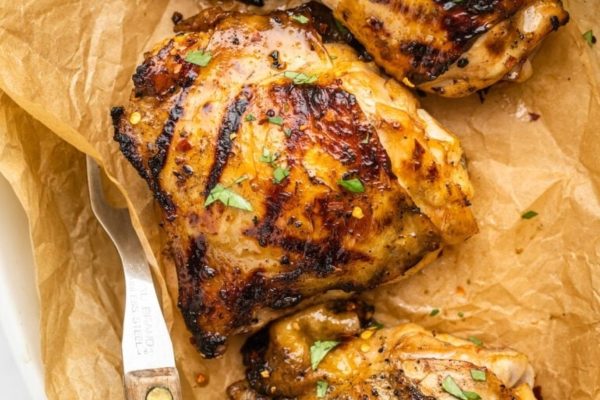 Grilled chicken breasts on a piece of paper.