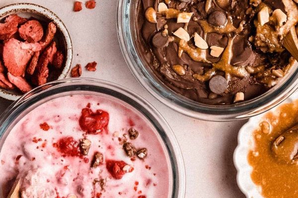 Three bowls of ice cream with different toppings.