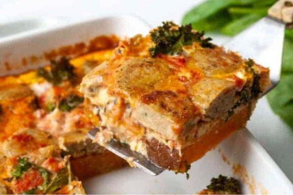 A fork is being used to take a bite out of a casserole.