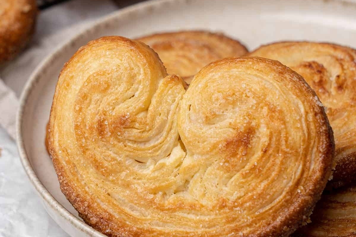 Heart shaped puff pastry pastries on a plate.