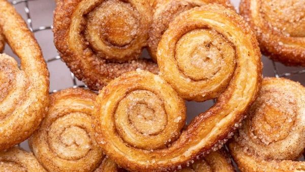Swedish cinnamon buns on a cooling rack.