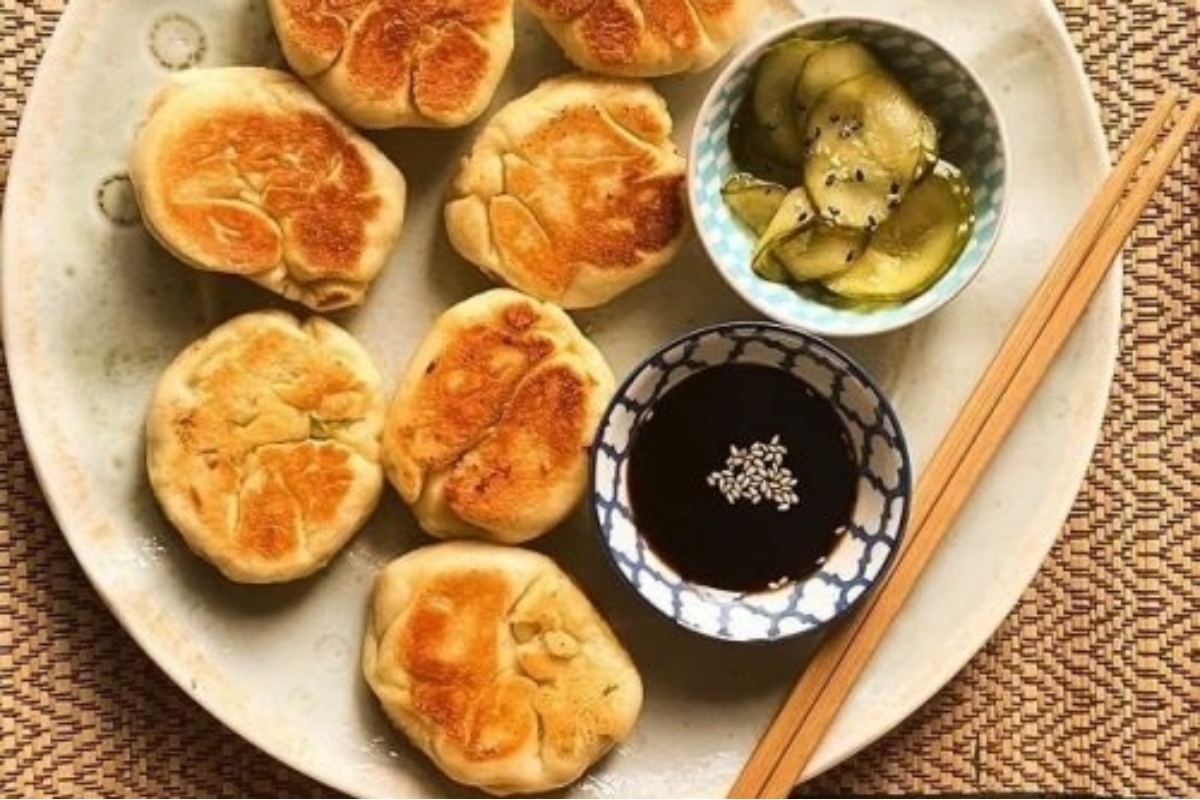Served Japanese dumplings on a plate with chopsticks.