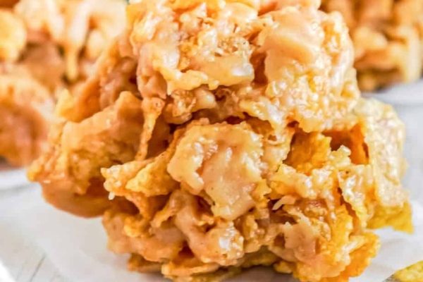A pile of peanut butter fudge on a white plate.