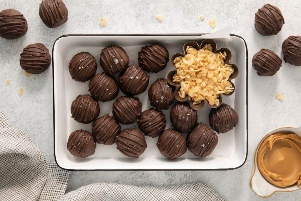 Chocolate peanut butter truffles on a tray.